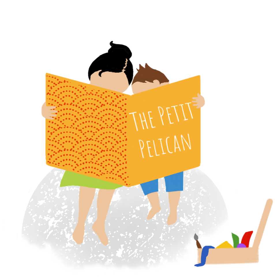 Mother and child reading together the magazine The Petit Pelican with an open craft box in front